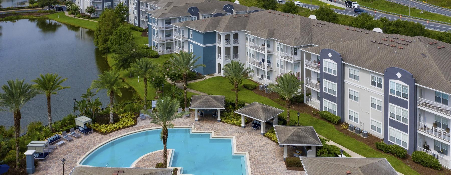 a pool next to a building next to a body of water