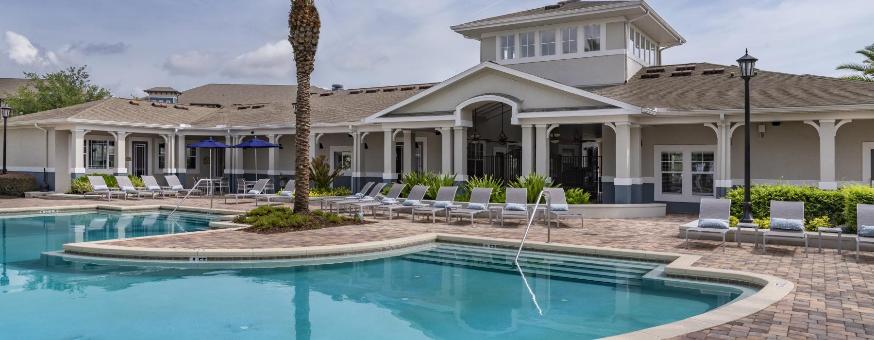 a swimming pool in front of a large building