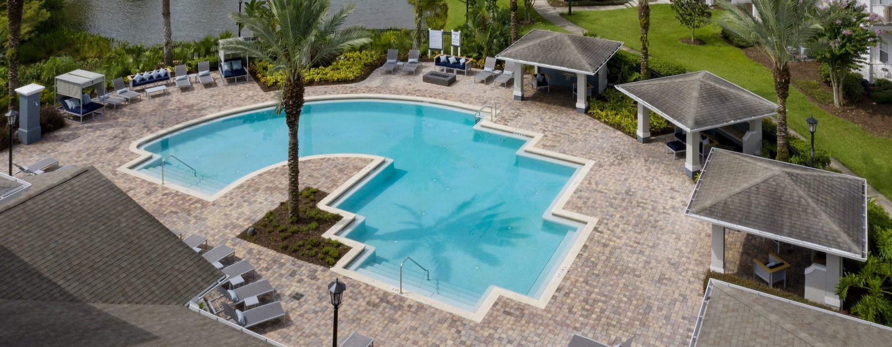a courtyard with a pool and chairs