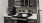 a kitchen with a microwave oven and a refrigerator and dark cabinets