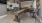 a room with a shuffleboard table and chairs