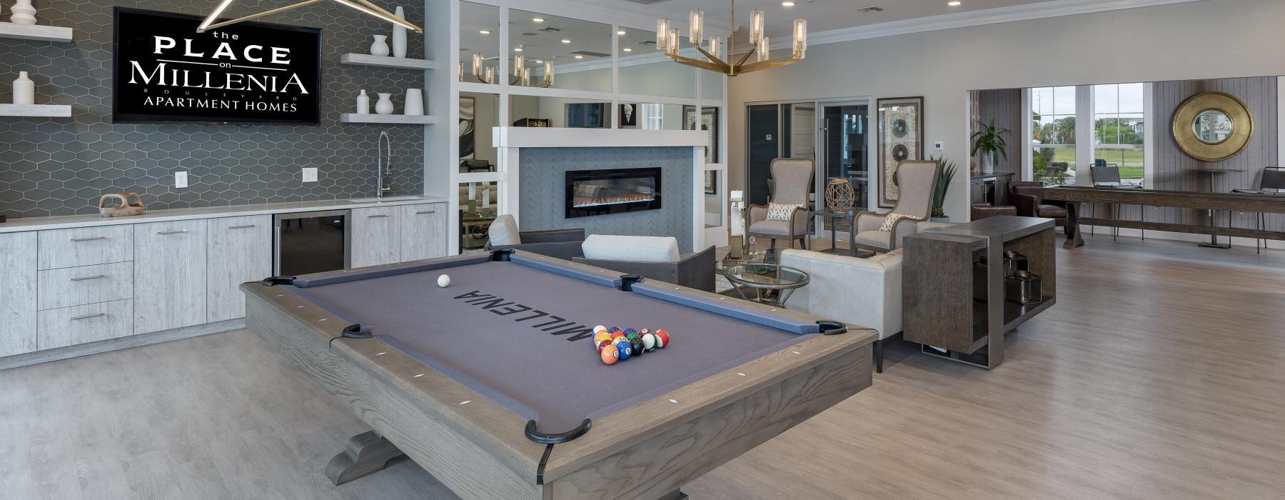 a large room with a fireplace and a pool table