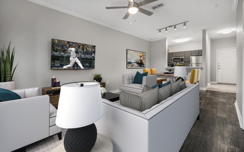 a living room with a white couch and a white table and tv