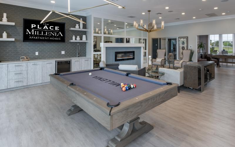 a large room with a fireplace and a pool table