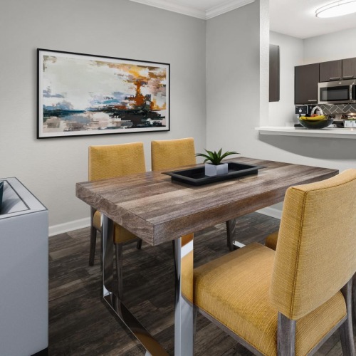 Generous living spaces to relax and unwind a dining room table with chairs leading into a kitchen